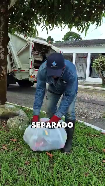 Operario recoge una bolsa de reciclaje separado en la ruta casa a casa de San Luis de Gaceno